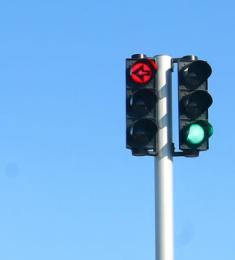 Grønt lys i lysregulering med rød pil til bilisterne i svingbanen.